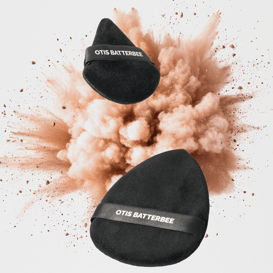 Powder puffs for setting loose powder over the face and body by Otis Batterbee.